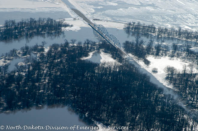 The bridge on this rural road is passable, however the approaches are flooded.