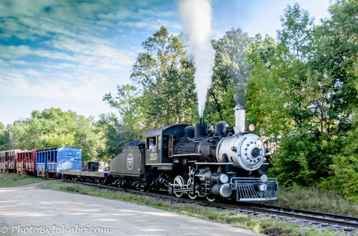 The steam whistle announces the arrival of a trainload of passengers.
